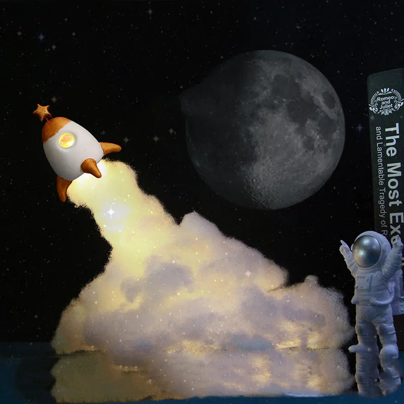 DIY astronaut rocket night light kit with LED string lights and build materials on a desktop