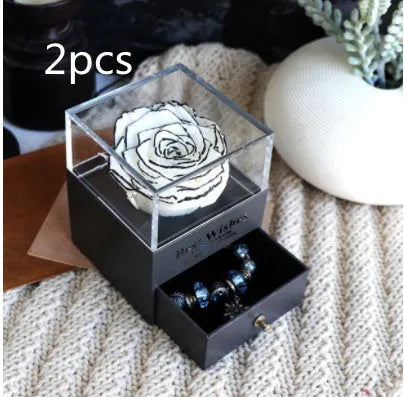 Eternal Flower gift box with preserved roses and carnations inside, measuring 8.5 cm square by 10.5 cm high