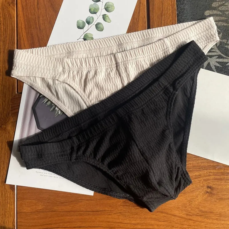 Men's solid colour cotton triangle briefs in mid-waist style, shown in apricot and black colour options.