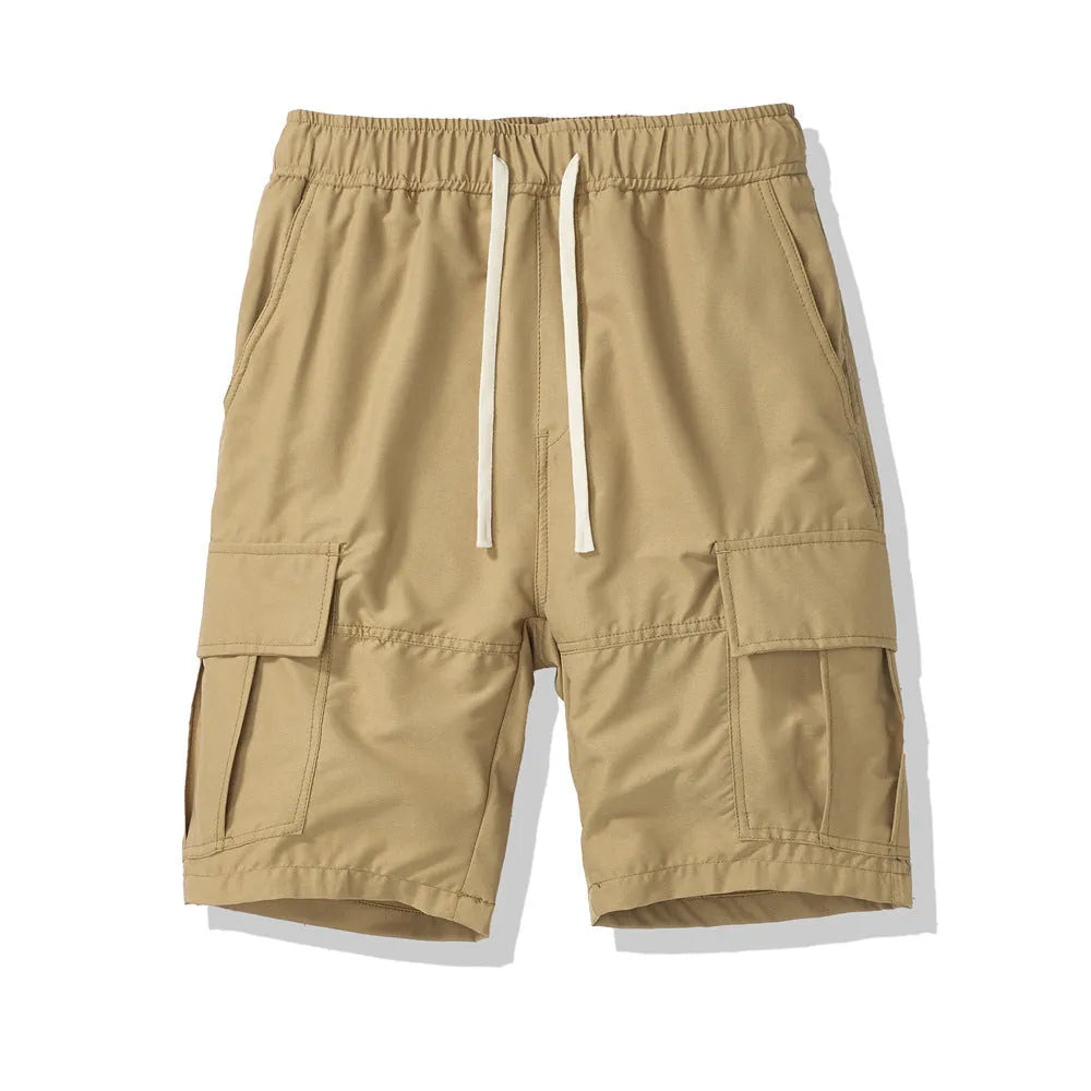 Man wearing loose-fit black cropped trousers with multiple pockets, summer casual style