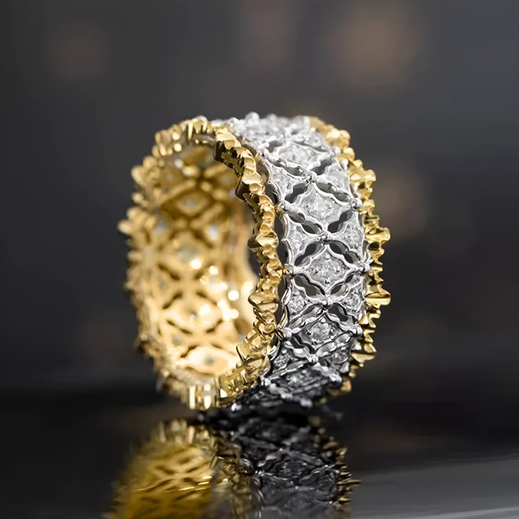 Geometric two-tone gold plated ring with round zircon centre on a plain background.