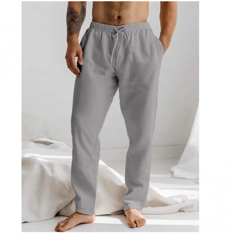 Men's loose straight-leg trousers in light blue with an elastic waistband and drawstring detail.