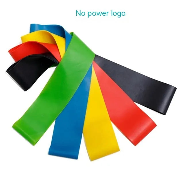 Set of five colour-coded yoga resistance straps in green, blue, yellow, red, and black on a gym mat.