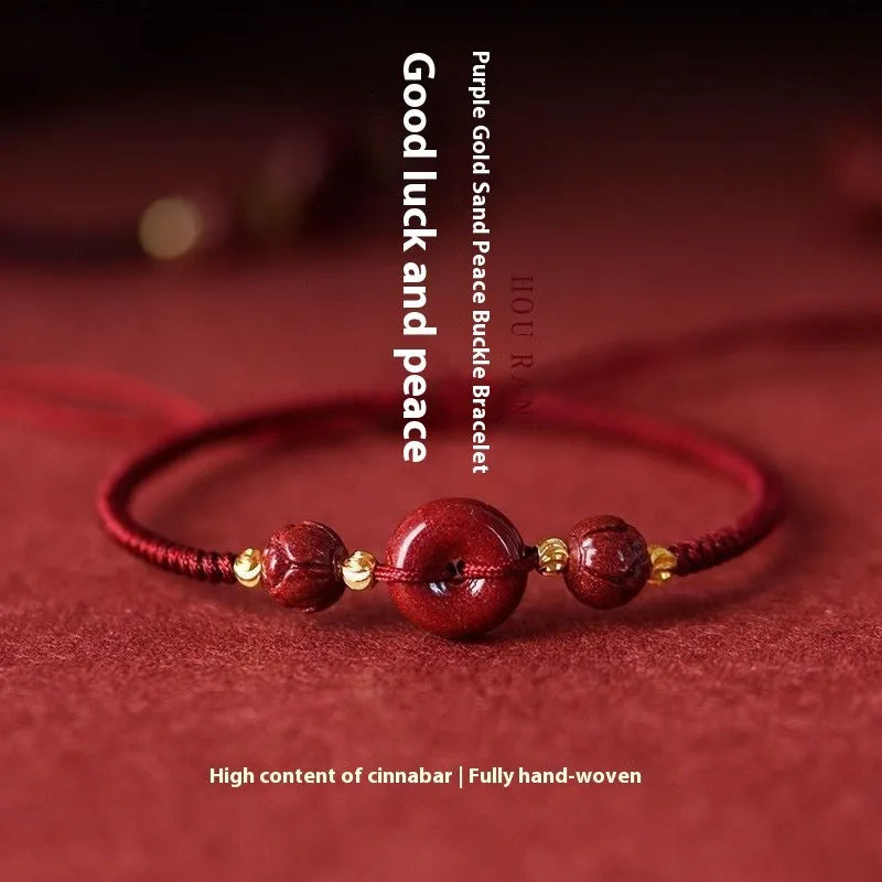 Heart-shaped cinnabar bead on an adjustable knot rope bracelet with a decorative peace buckle closure.