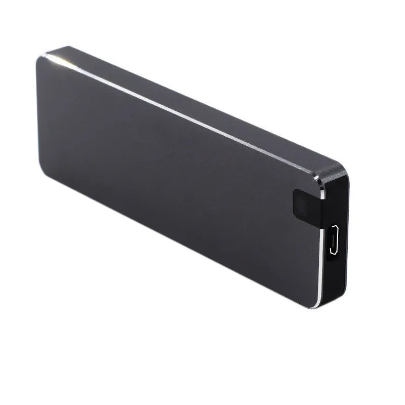 White metal portable external SSD hard drive with USB cable on a grey background