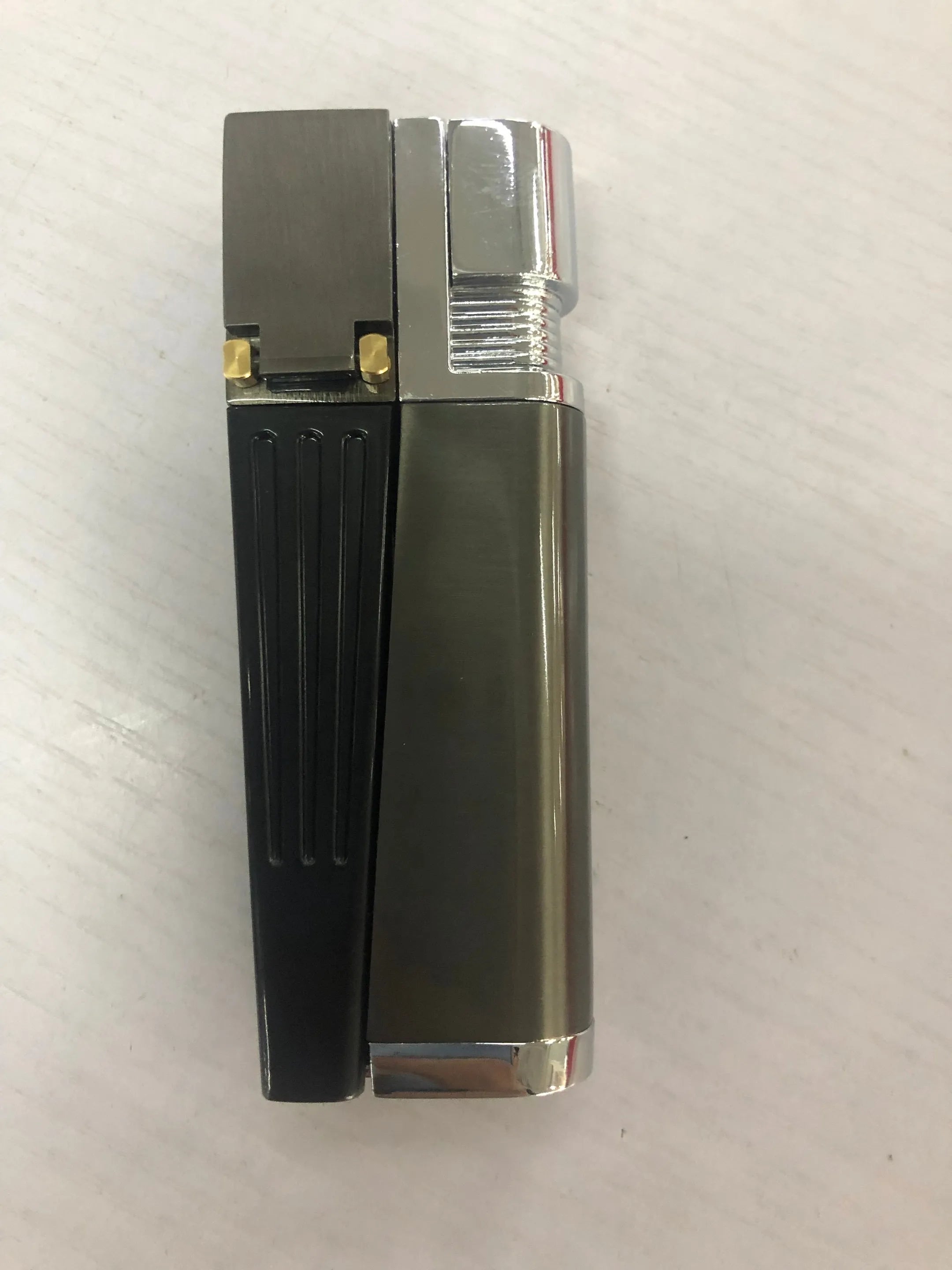 Silver foldable metal pipe lighter shown open, revealing the lighter mechanism and a small stash compartment.