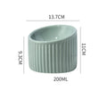 Dark green ceramic elevated cat bowl with tilted design on a wooden surface.