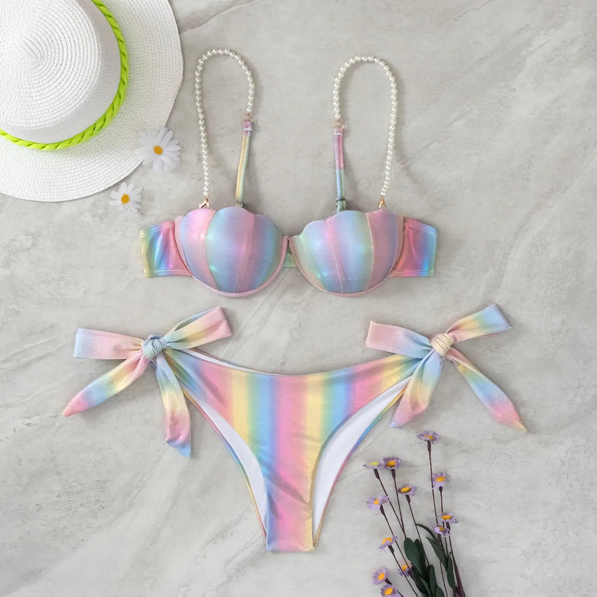 Women's shell rainbow coloured split bikini swimsuit with tied design on a mannequin.