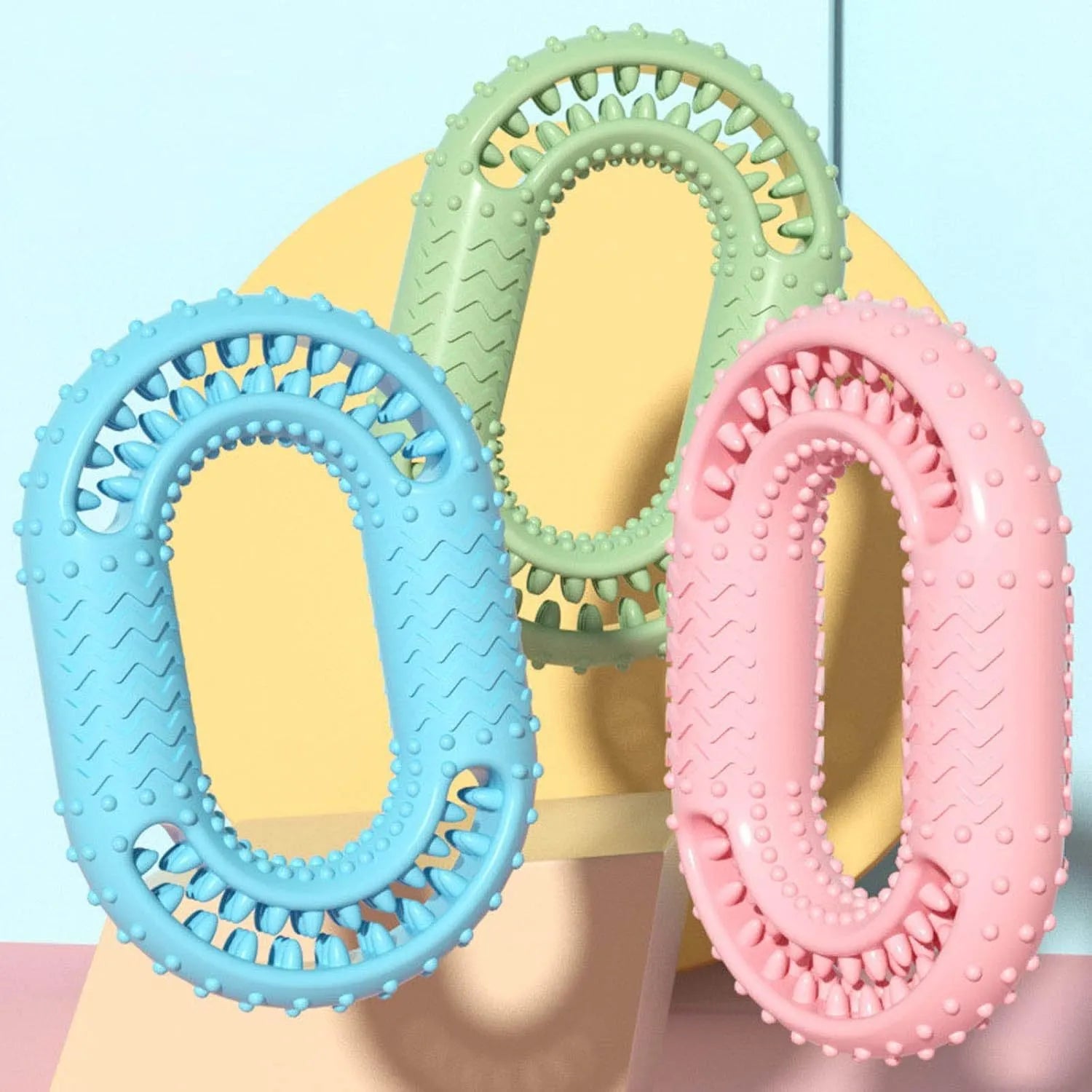 Blue, green, and pink heavy-duty o-ring shaped dog chew toy for aggressive chewers.