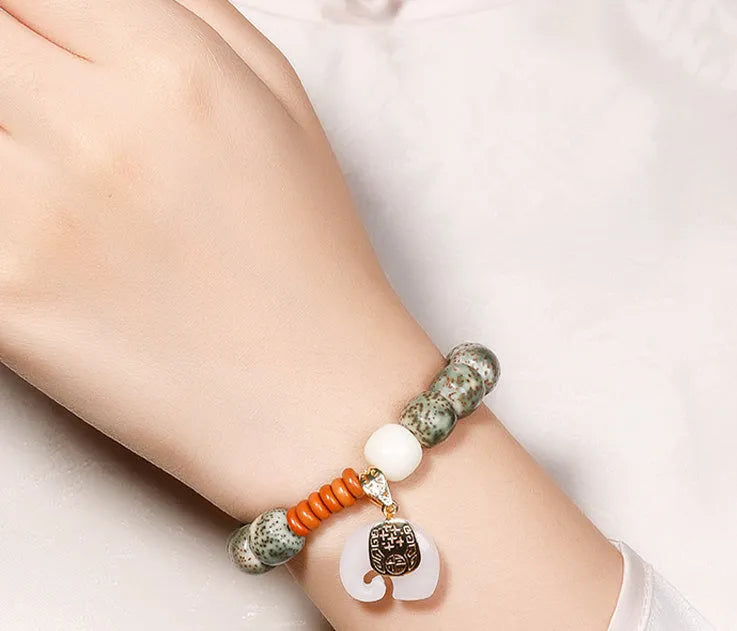 Jade green star moon bodhi bracelet with 10mm geometric beads on white background