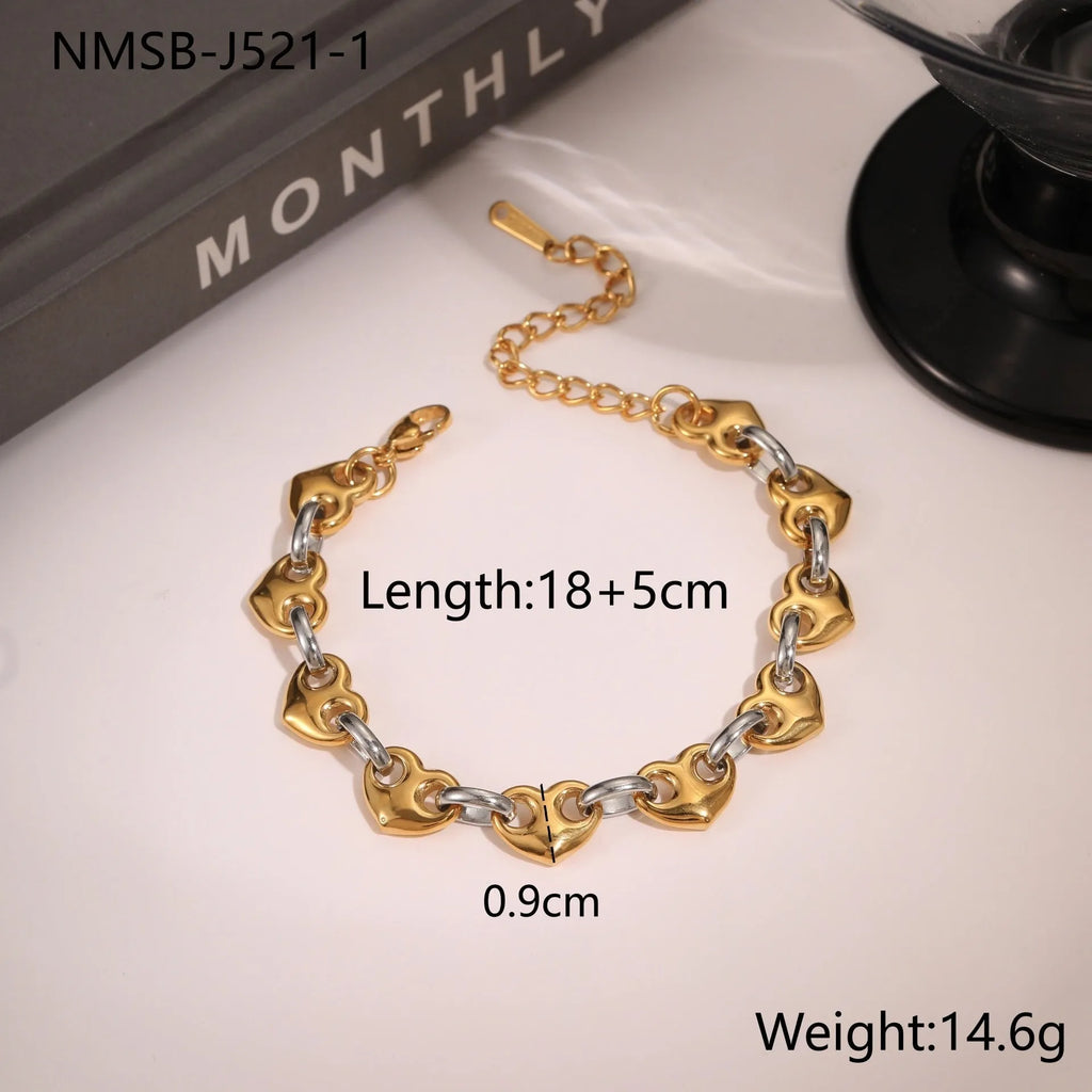 Hollowed-out heart geometry bracelet in stainless steel with gold electroplated finish on a wrist.