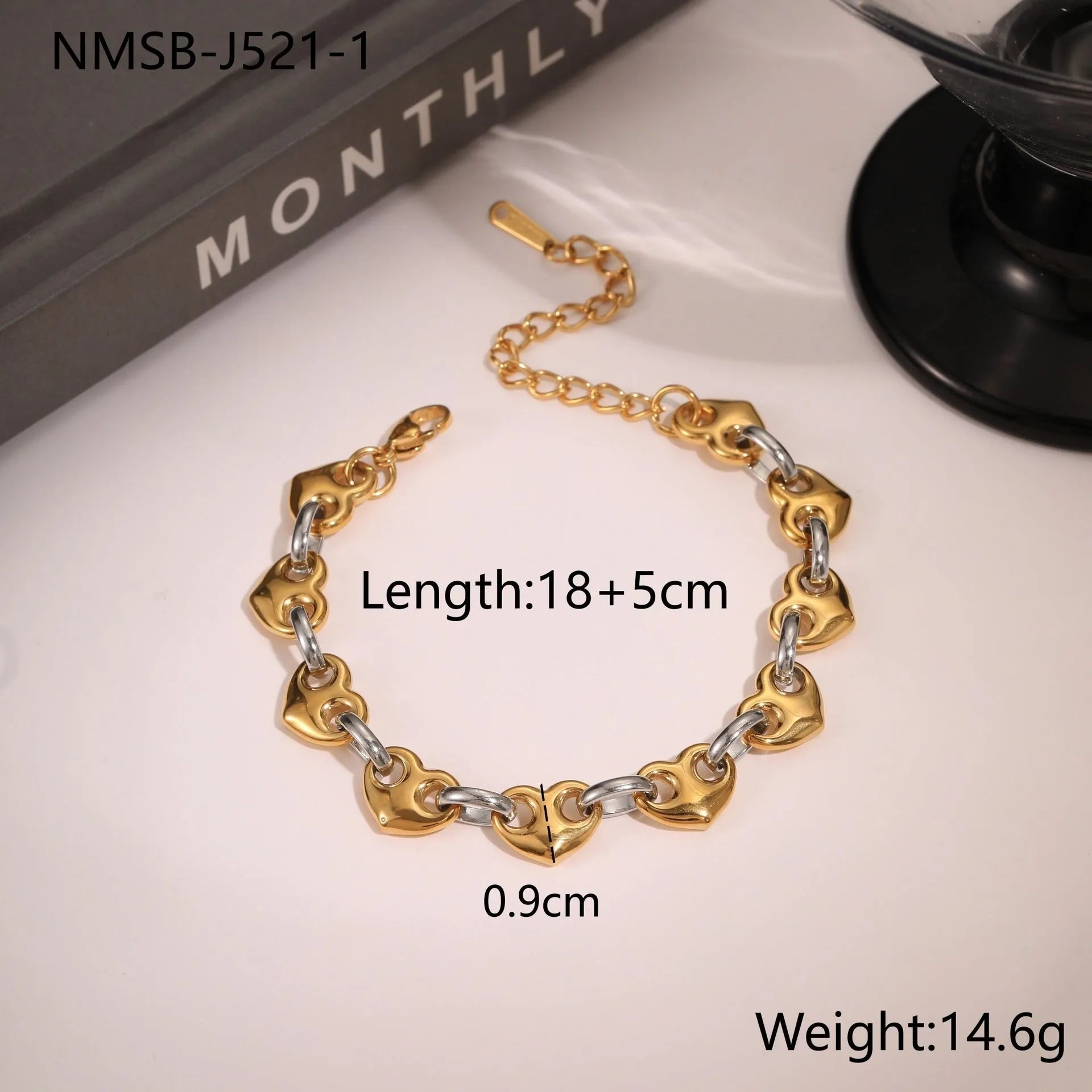Hollowed-out heart geometry bracelet in stainless steel with gold electroplated finish on a wrist.