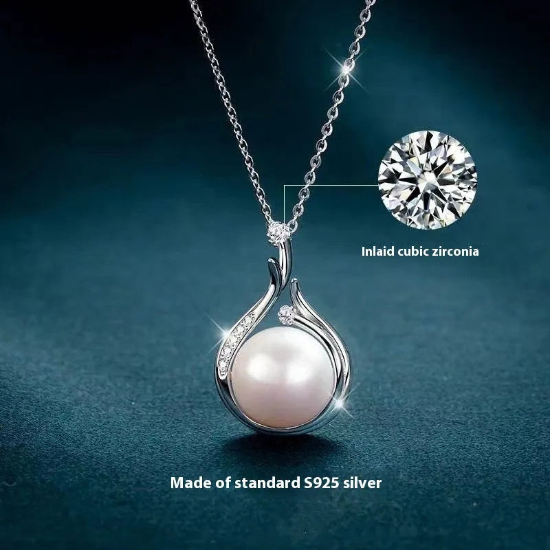 S925 silver necklace with natural freshwater pearl and geometric mother-of-pearl pendant on cross chain over a knitted sweater