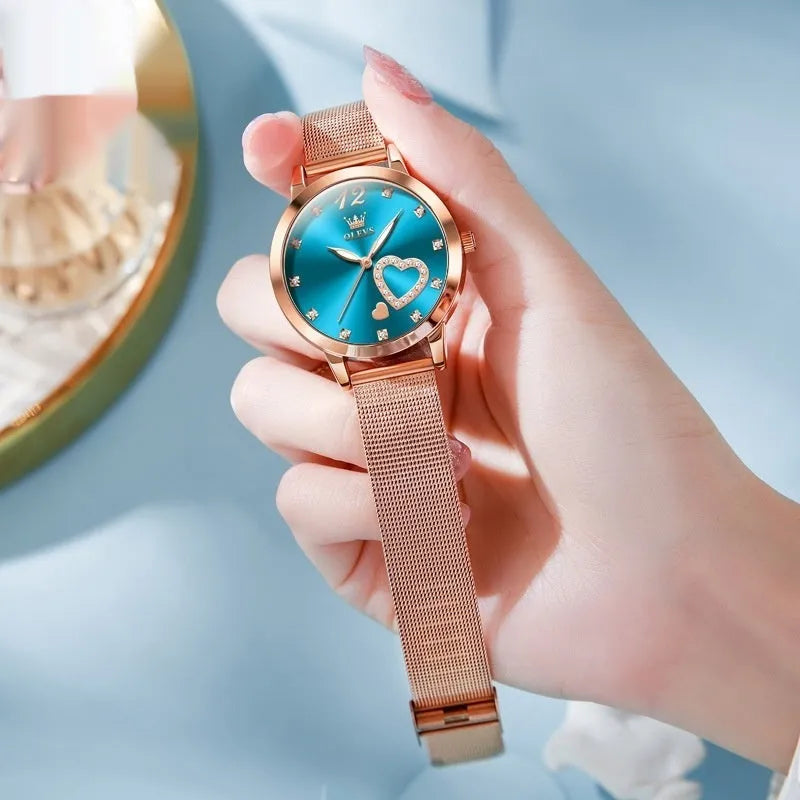 Women's mesh strap watch with rose shell casing showing six face colour options