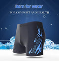 Men's plus-size black swimming trunks with blue flame pattern and matching swim cap