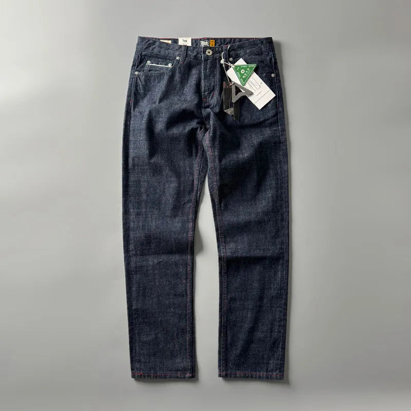 Men's straight leg denim trousers in a primary blue wash, showing front view on a hanger.