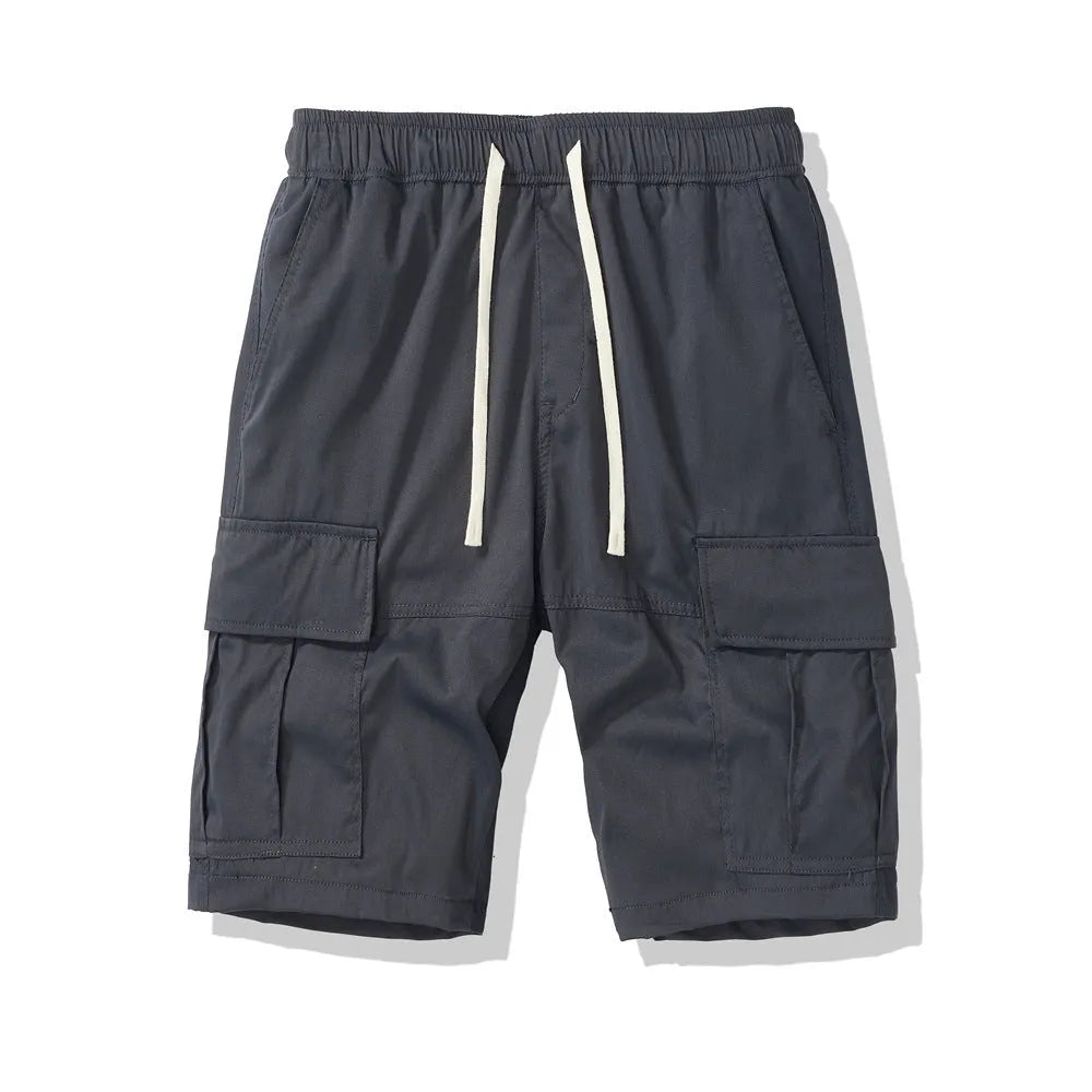 Man wearing loose-fit black cropped trousers with multiple pockets, summer casual style