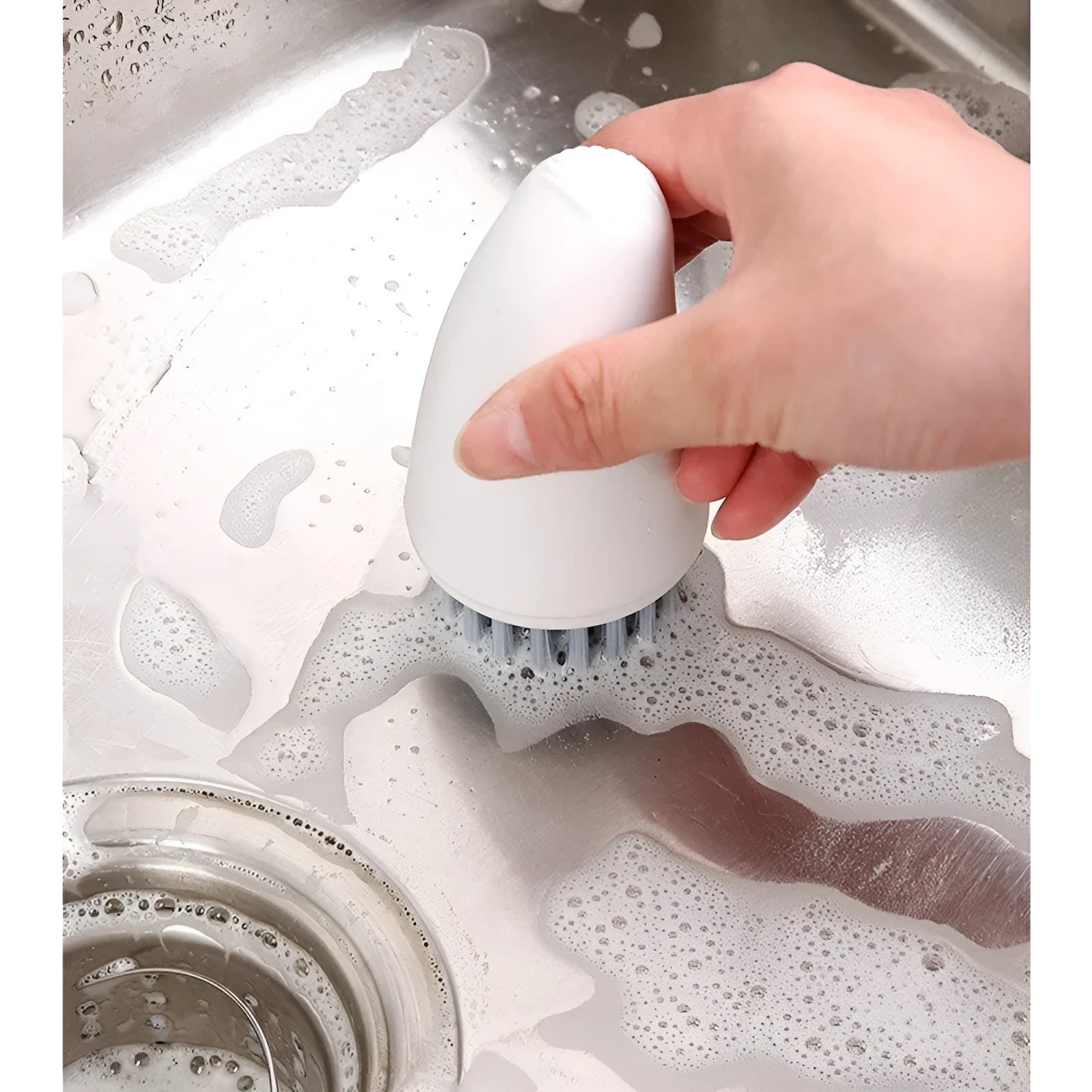 Orange and white carrot-shaped kitchen brush with nylon bristles for scrubbing.
