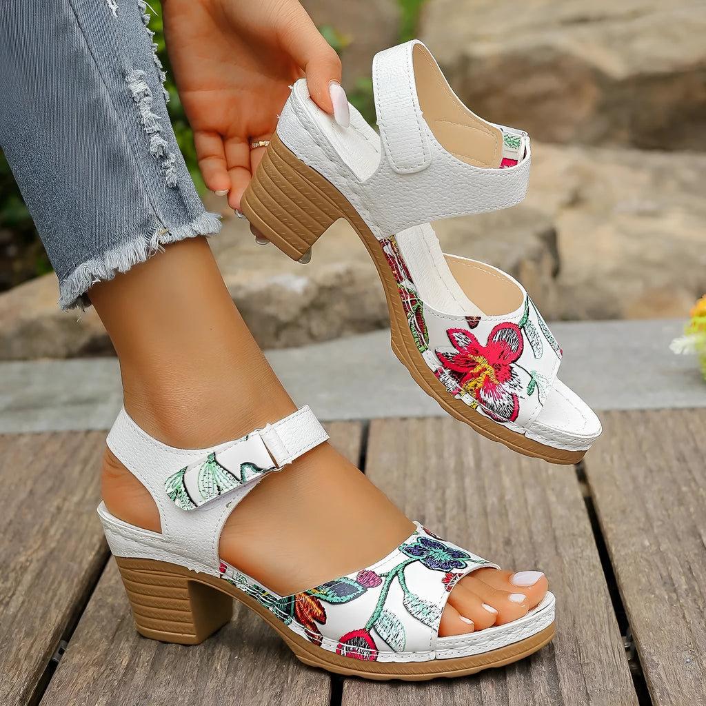 White women's casual high heel sandals with a prominent Velcro strap buckle closure.