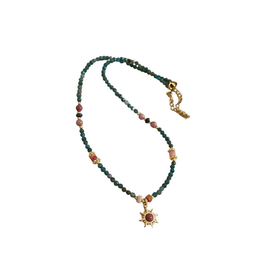 Stone sun pendant and freshwater pearl French court style necklace on a model