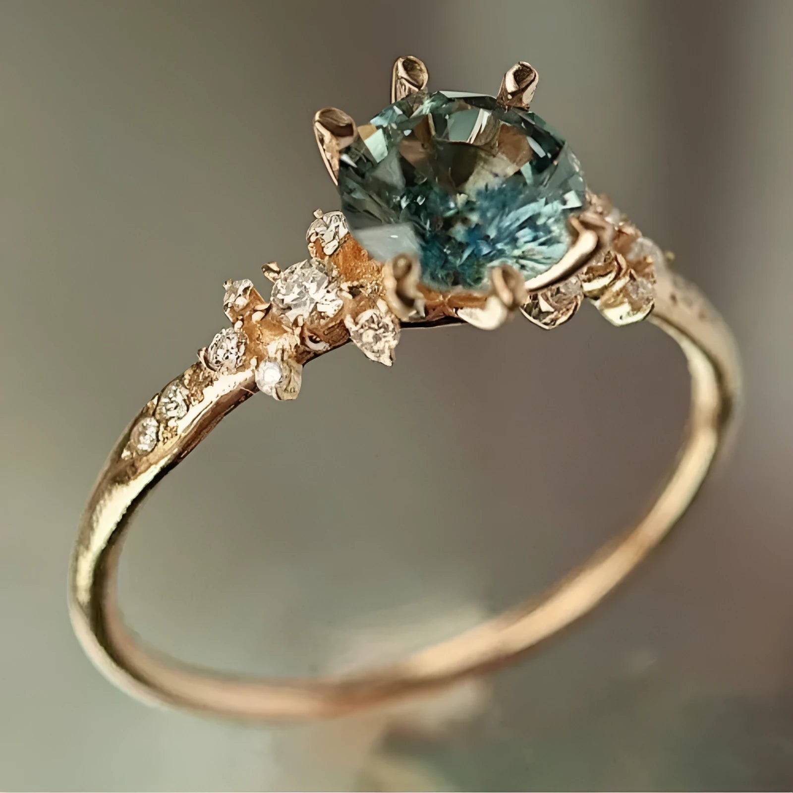 Gold geometric ring with chamfered square pattern and claw-set zircon stone