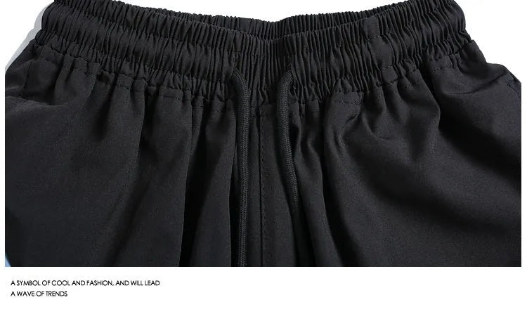 Black and grey quick-drying sports shorts with elastic waistband and loose fit for training