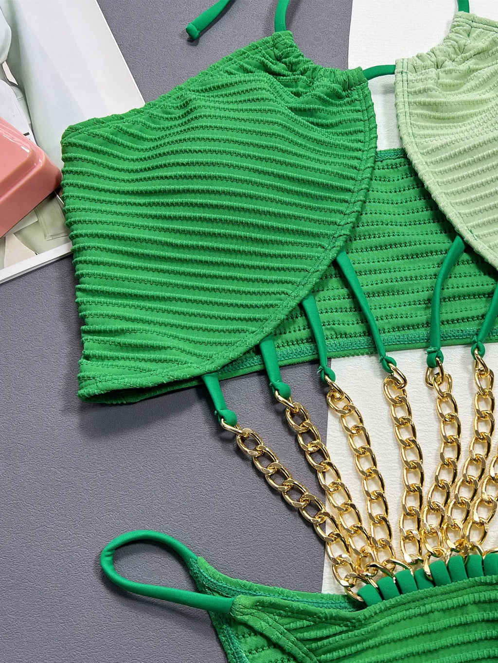 Green women's one-piece swimsuit with a hollow sexy cut on a mannequin.
