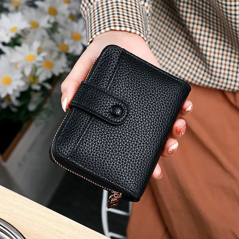 Women's short organ wallet with lychee pattern in pu leather, showing antibacterial lining and reinforced sewing thread detail