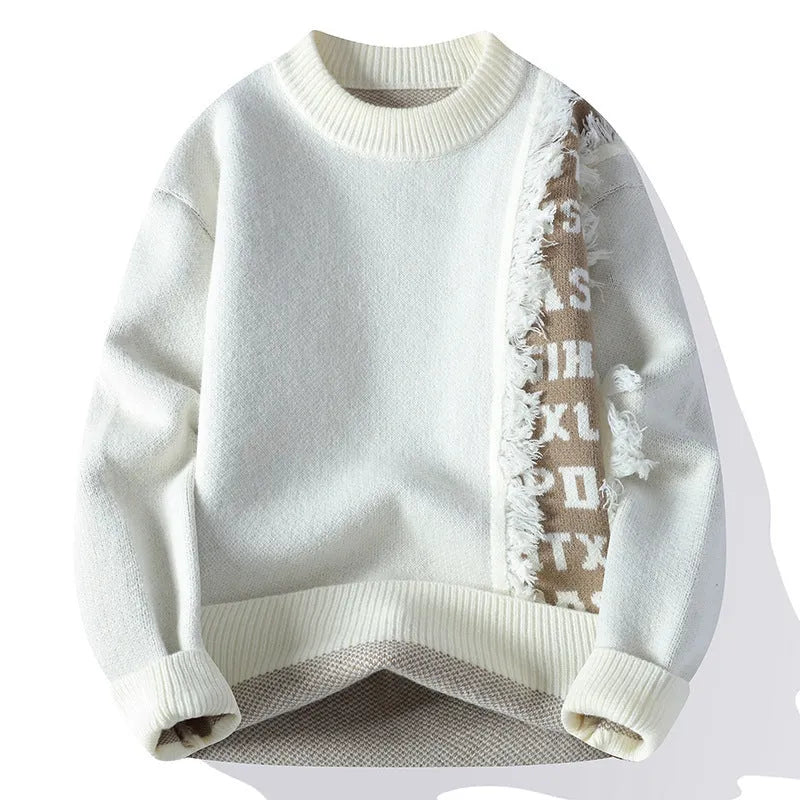 Man wearing a loose fit grey knitted pullover with long sleeves and a ribbed hemline.