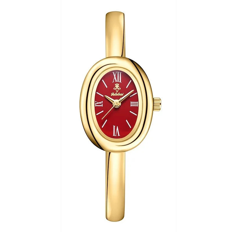 Women's slim oval retro quartz watch in gold colour on wrist
