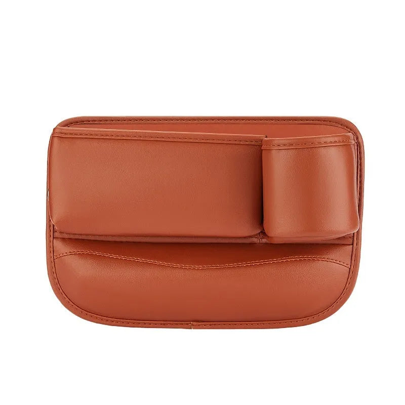 Car seat gap storage box with water cup holder in black leather beside driver seat