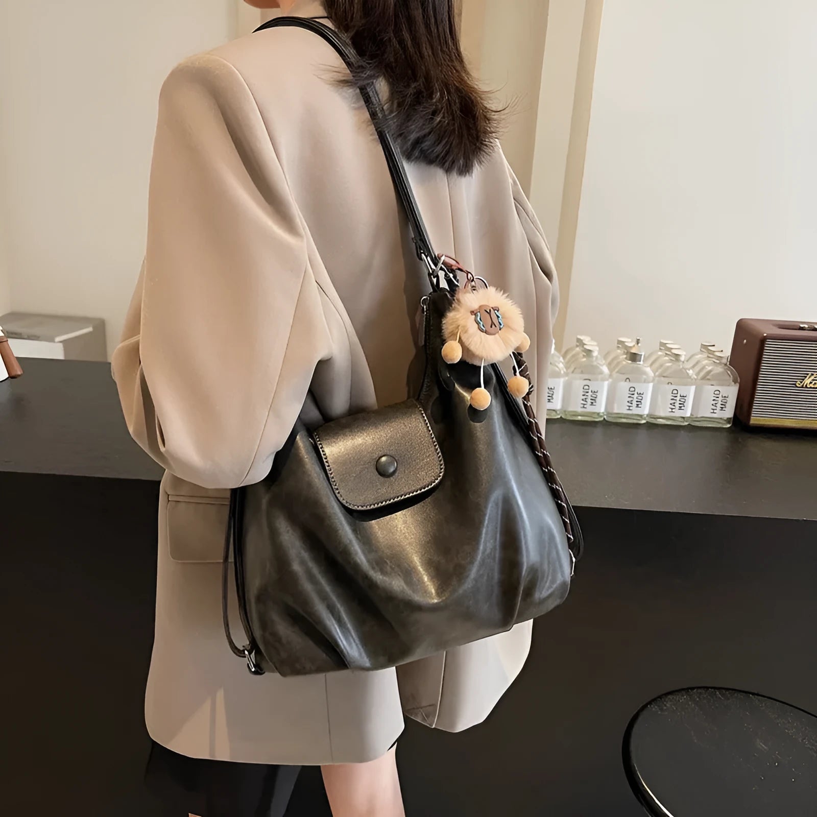 Women's PU leather shoulder bag in horizontal square shape with single strap, showing interior mobile phone compartment