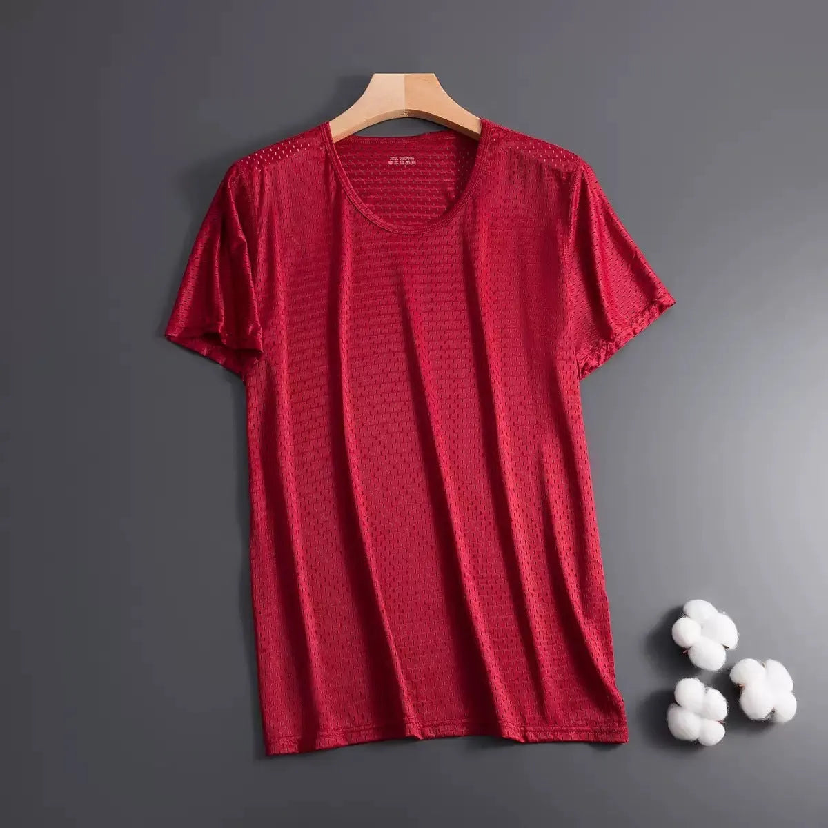 Man wearing a thin grey Ice Silk short sleeve crew neck t-shirt with a loose fit.