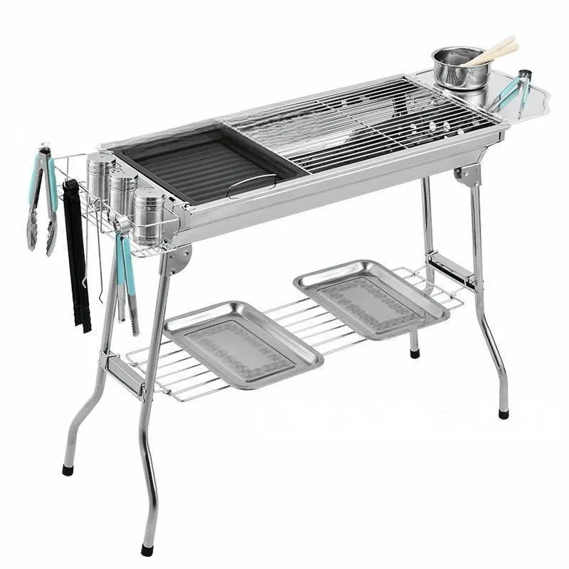 Large stainless steel portable barbecue oven with flip-over charcoal stove design and included grills.