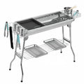 Large stainless steel portable barbecue oven with flip-over charcoal stove design and included grills.