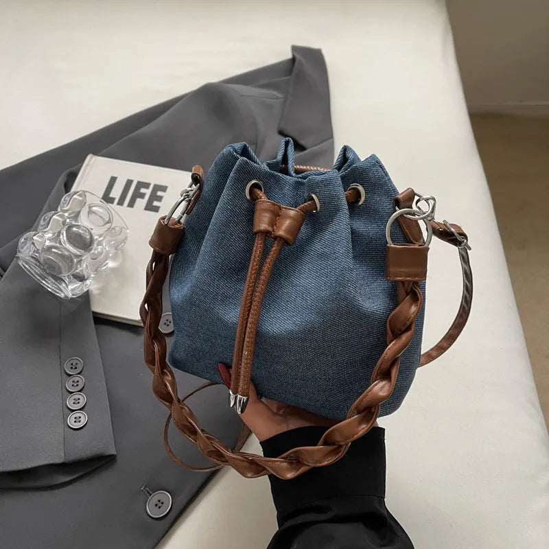 Blue synthetic leather cross body bucket bag with optional hanging ornaments