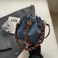 Blue synthetic leather cross body bucket bag with optional hanging ornaments
