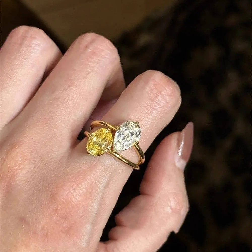 Open geometric ring with water drop shaped zircon stones in contrasting colours