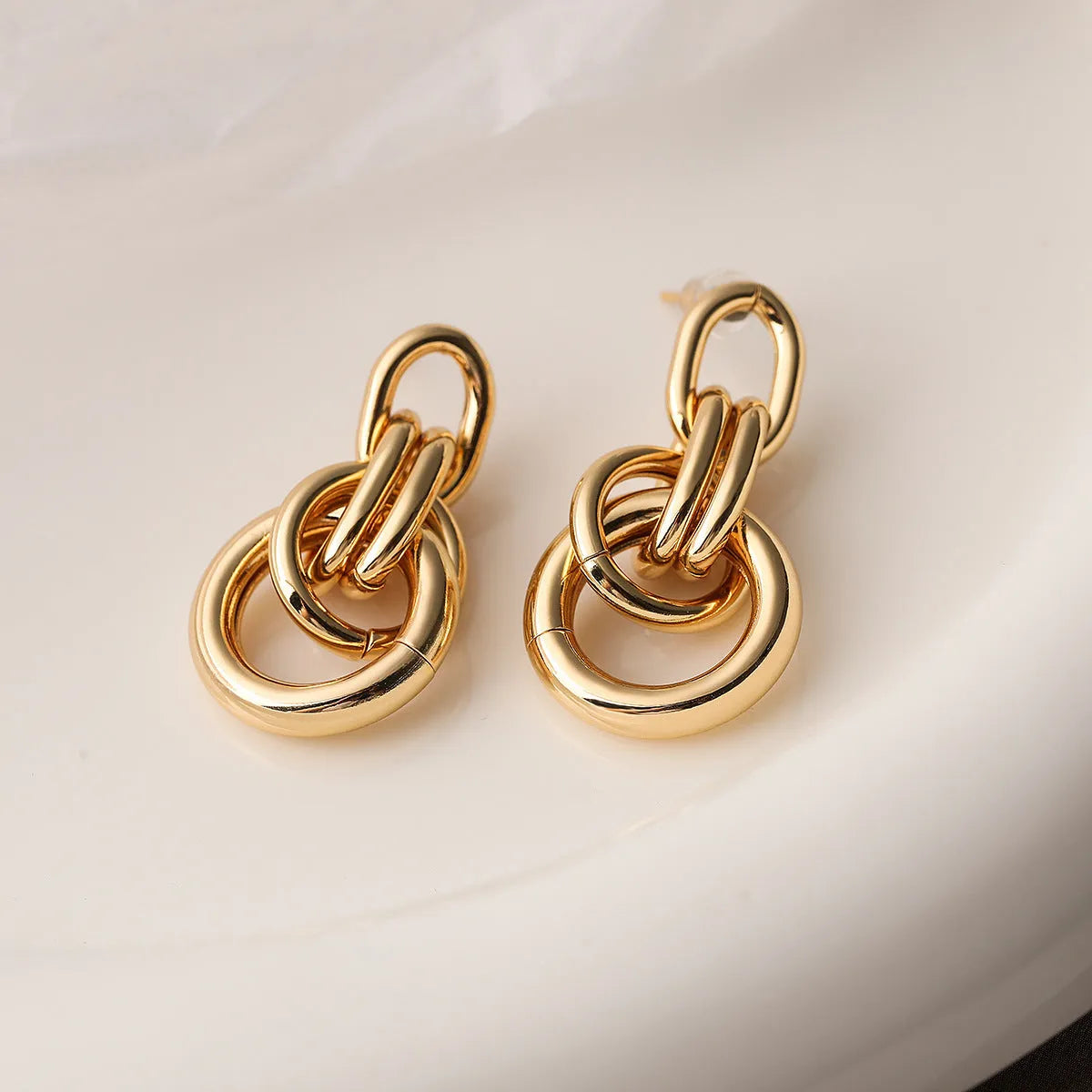 Women's gold geometric earrings with irregular shapes and high-profile metallic style