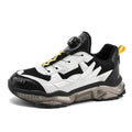 Men's black casual sneakers with a rotating button closure and low-top design.