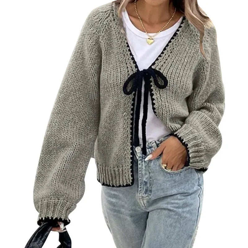 Gray lace-up cardigan sweater with long sleeves and crocheted flower decoration on the front.