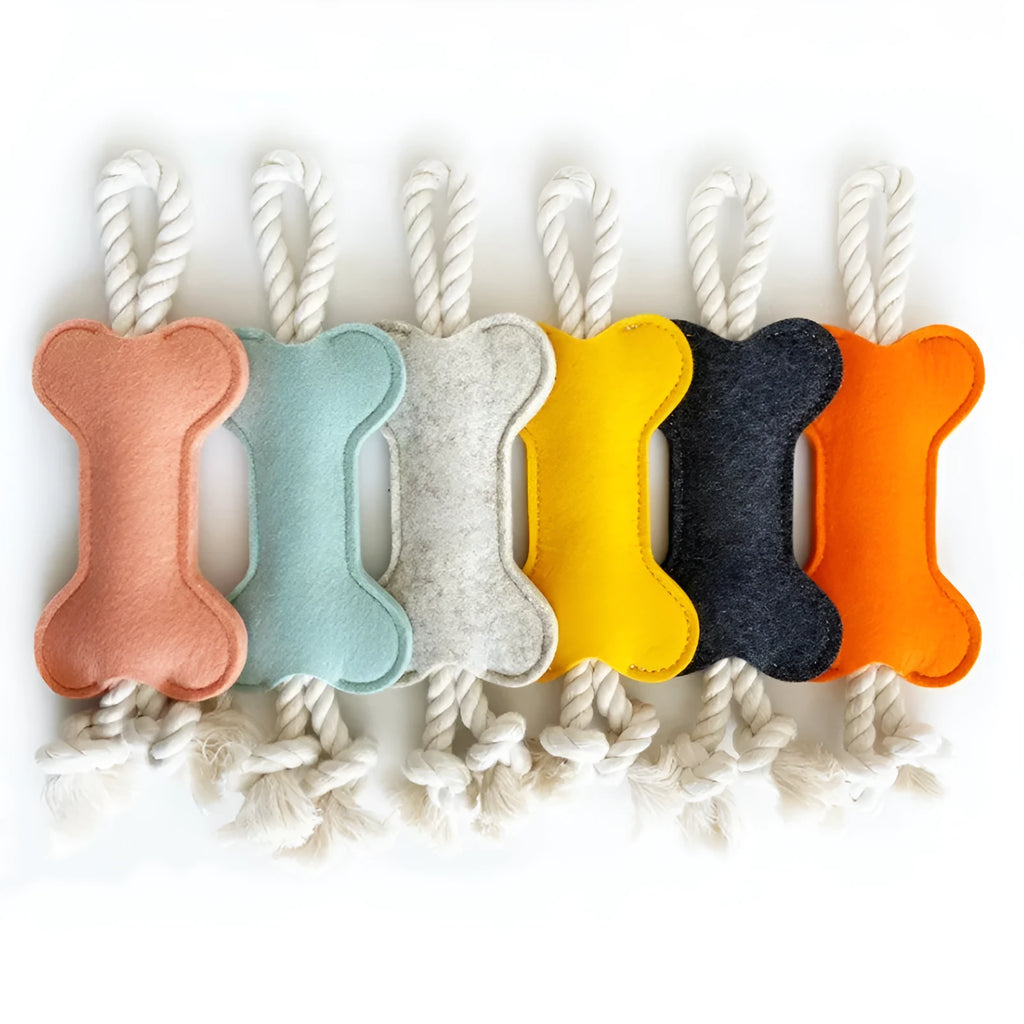 Bone-shaped dog chew toy in felt fabric with rope detailing, shown in various colours