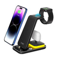 Black vertical wireless charging stand holding phone upright with smartwatch and headset charging