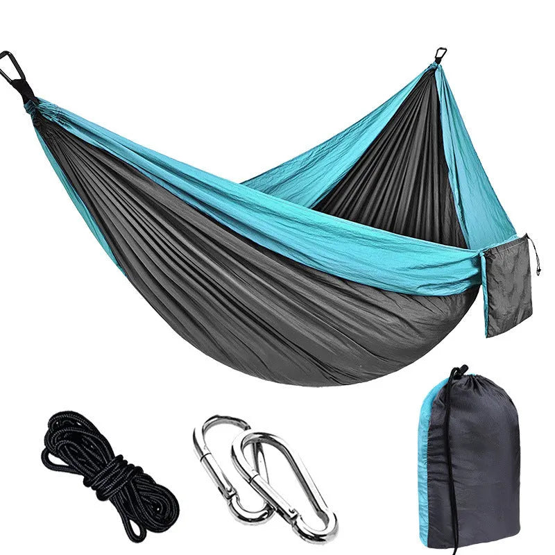 Double camping hammock with ropes and buckles shown in outdoor setting