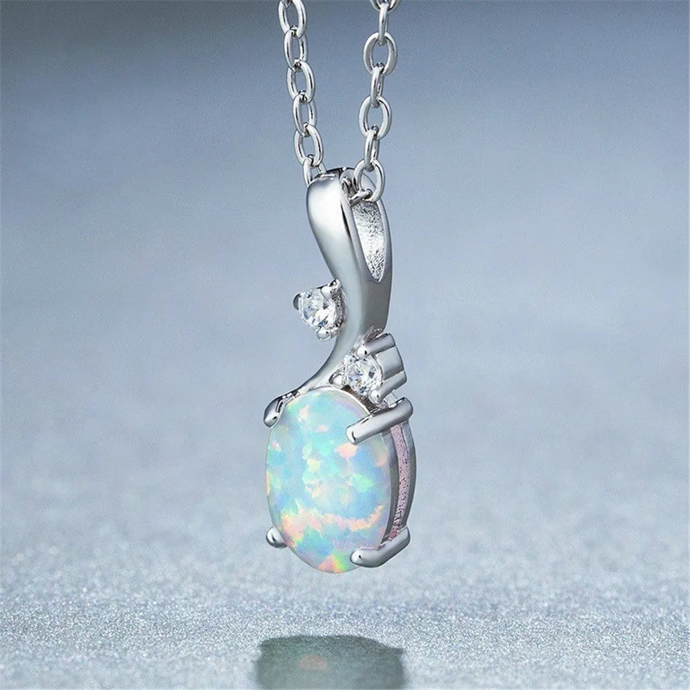 Close-up of a water drop shaped opal pendant on an adjustable O-link chain, shown in a rose gold finish.