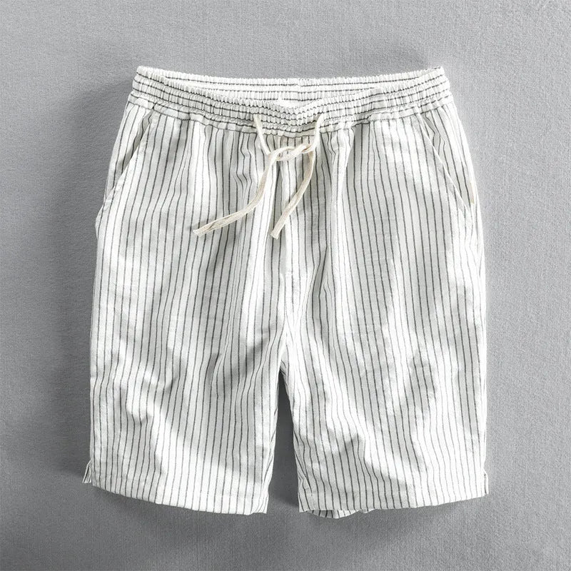 Man wearing black and white striped cotton casual shorts with a loose straight leg and elasticated waist.