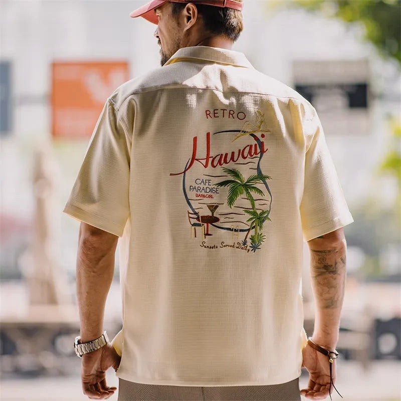 Men's light apricot shirt with botanical plant print and a Cuban collar.