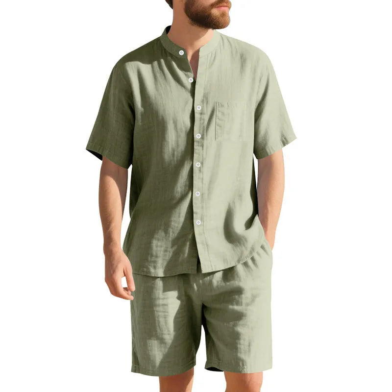 Man wearing a light blue short-sleeve linen blend suit jacket and matching shorts with a Henry collar.