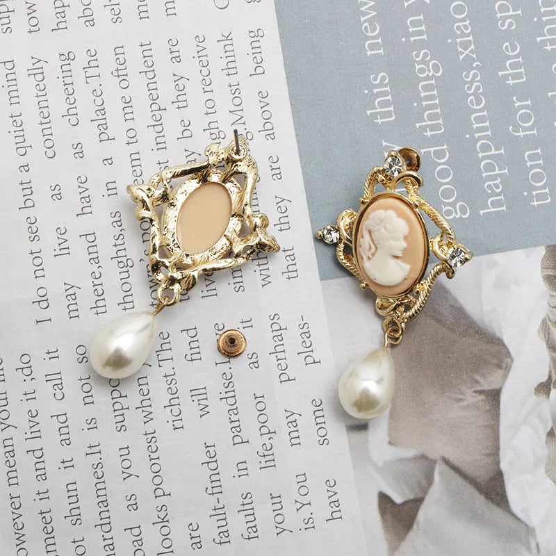 Gold alloy retro embossed geometric earrings on a surface