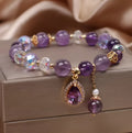 Close-up of a women's purple amethyst crystal bracelet with detailed micro inlay stone setting.